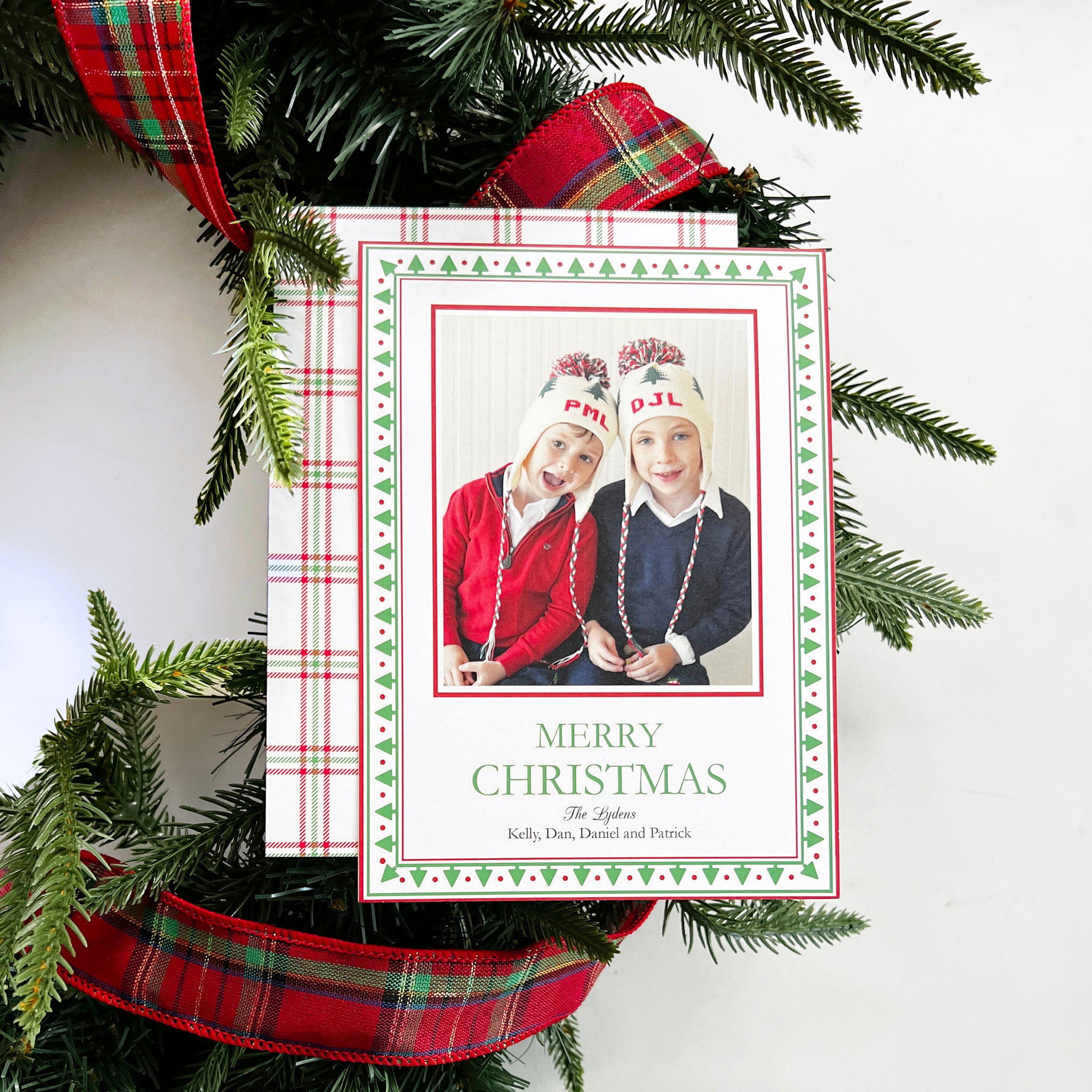 https://www.whhostess.com/cdn/shop/files/nordicchristmastreeborderphotocardonwreath_2048x.jpg?v=1695679904